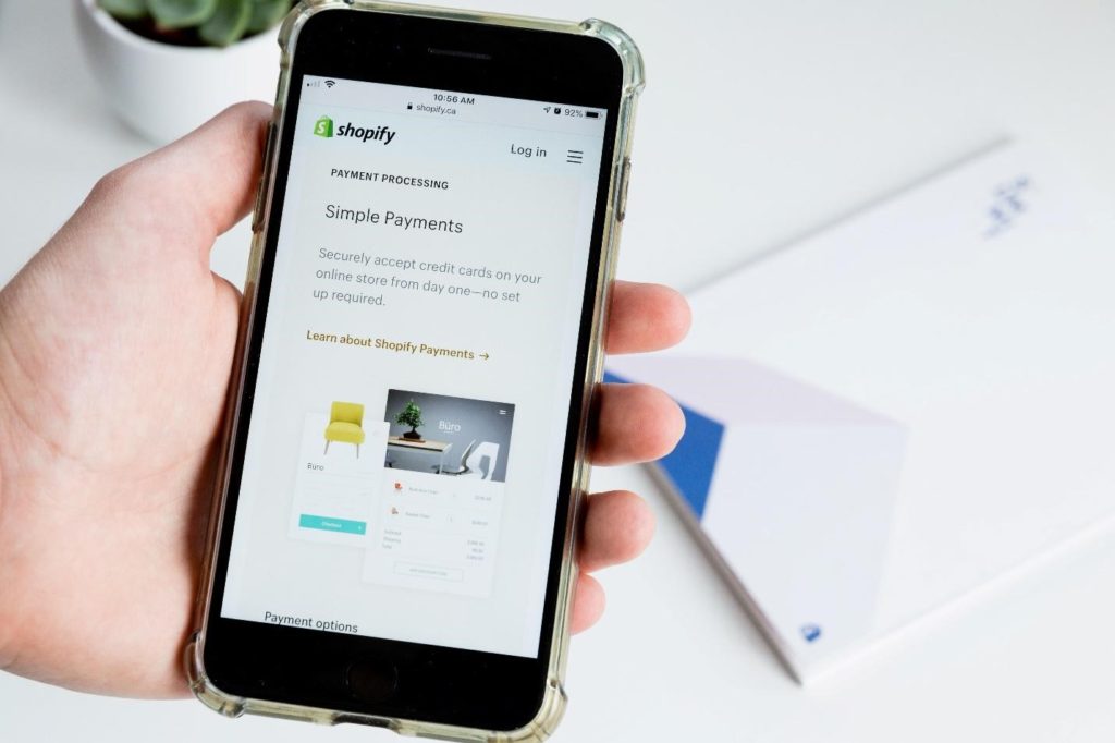 Under E-Commerce heading is a picture with Shopify displayed on a phone. @expandingwallet