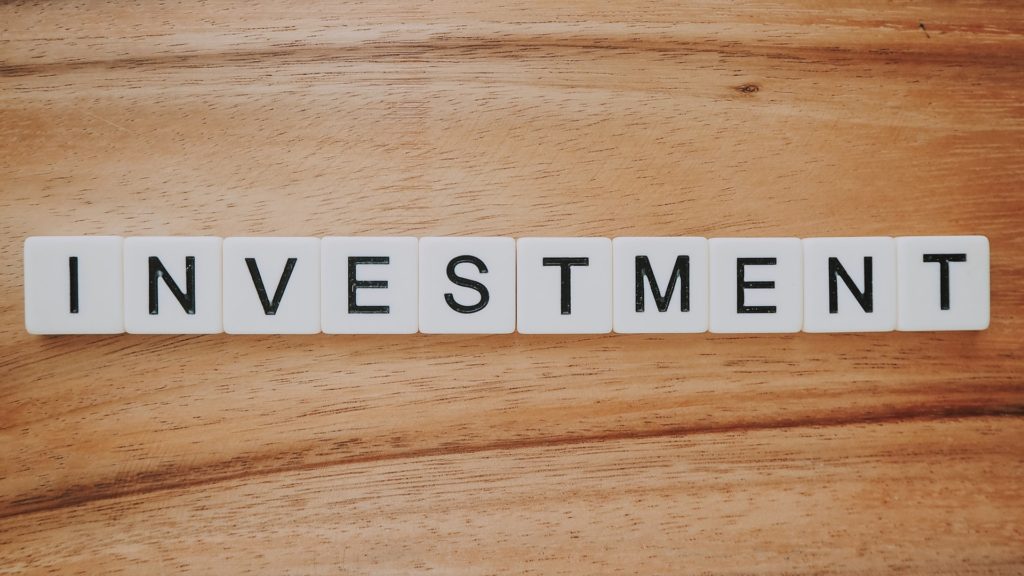 Investment spelled out with Scrabble pieces